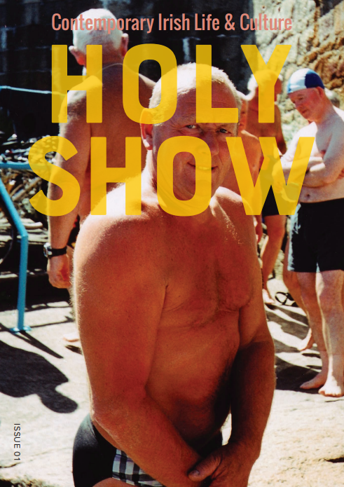 The front cover of issue one of Holy Show magazine. A man in a bathing suit stands in the sun with swimmers in the background.