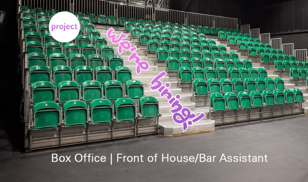 A graphic with a photo of the tiered seating in the space upstairs as the background. Over this is the Project Logo in the upper left corner, with text that reads "We're Hiring" diagonally down the stairs and text that reads "Box Office | Front of House/Bar Assistant" on the ground at the bottom of the image.