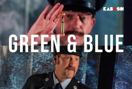 Image of two men in police uniforms, one in green, the other in blue. The officer in green holds up a golden bullet to the camera. Text over the images reads Green & Blue. The Kabosh logo sits in the upper right corner.