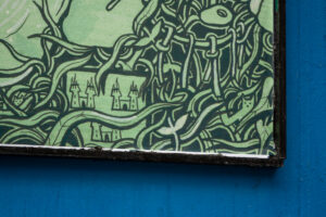 A close-up of an artwork detail on the Project billboard. The artwork shows a green and black drawing of the crest of Dublin nestled in dense foliage.